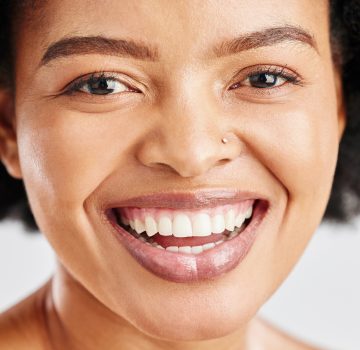 Portrait, skin care and beauty of a black woman with dermatology, cosmetics or natural makeup. Closeup and face of happy African female model in studio for facial glow, self love and teeth smile.