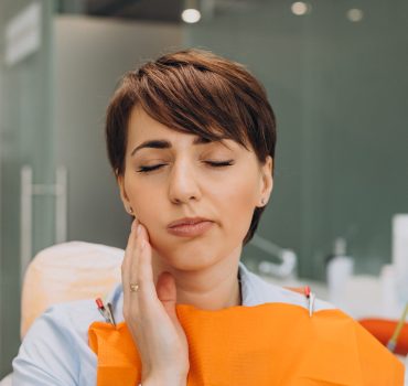 young-woman-having-tooth-ache-waiting-dentist-min-scaled